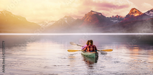 An adventurous couple in kayak paddle on a lake with rocky mountain background, Inspirational travel and leisure recreational, peaceful serene isolation