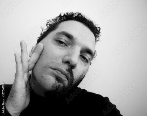Close-up portrait of a handsome young man with brave manly face. Male beauty.
