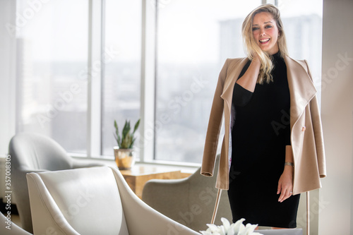 Beautiful sophisticated professional model wearing modern fashion business outfit, fun and playful personality, smiling and cheerful