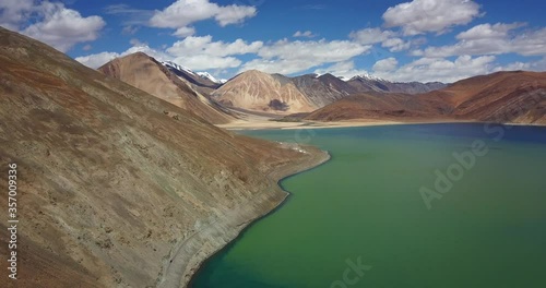 Beautiful view of the turquoise Pangong lake, serving as a border between China and India in the Himalayas, in Ladakh, surrounded by the Himalayan peaks, stunning travel destination in India