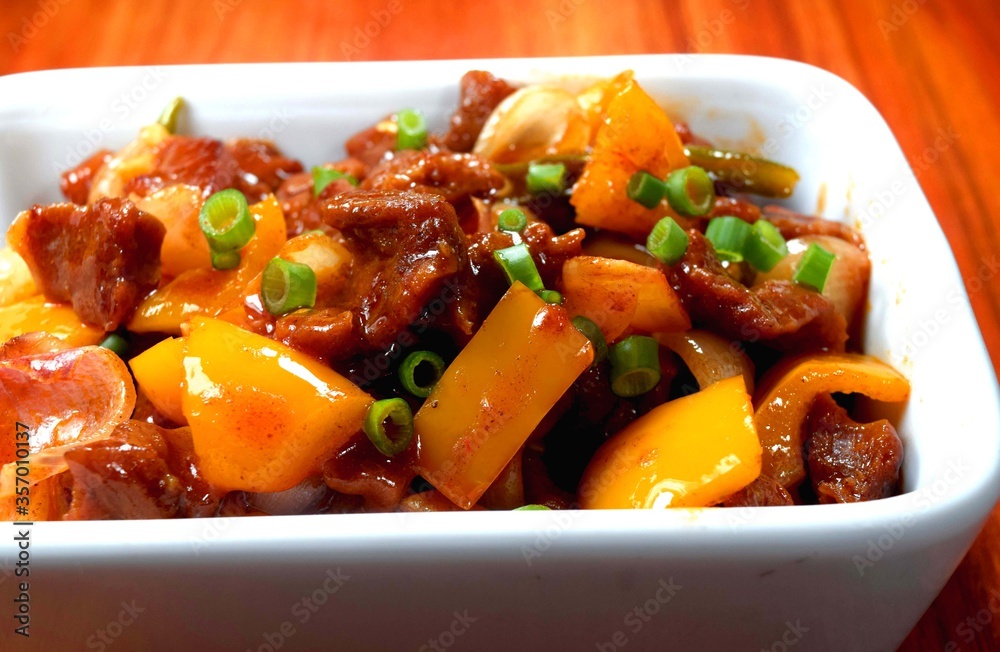 Beef stew with potatoes and vegetables. Closeup view of delicious Chinese chili beef . Chili beef Garnished with spring onion. Beef stew with potatoes and vegetables. Closeup view of delicious Chinese chili beef . Chili beef Garnished with spring onion.