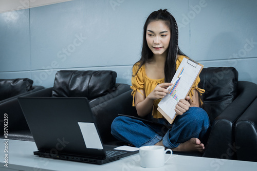 A young female university student presents her study through oline internet at home. A teenager woman spends time during covid-19 pandemic study online at home. Online and distance education concept. photo