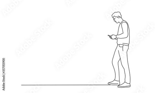 Line drawing vector illustration of young man using phone.