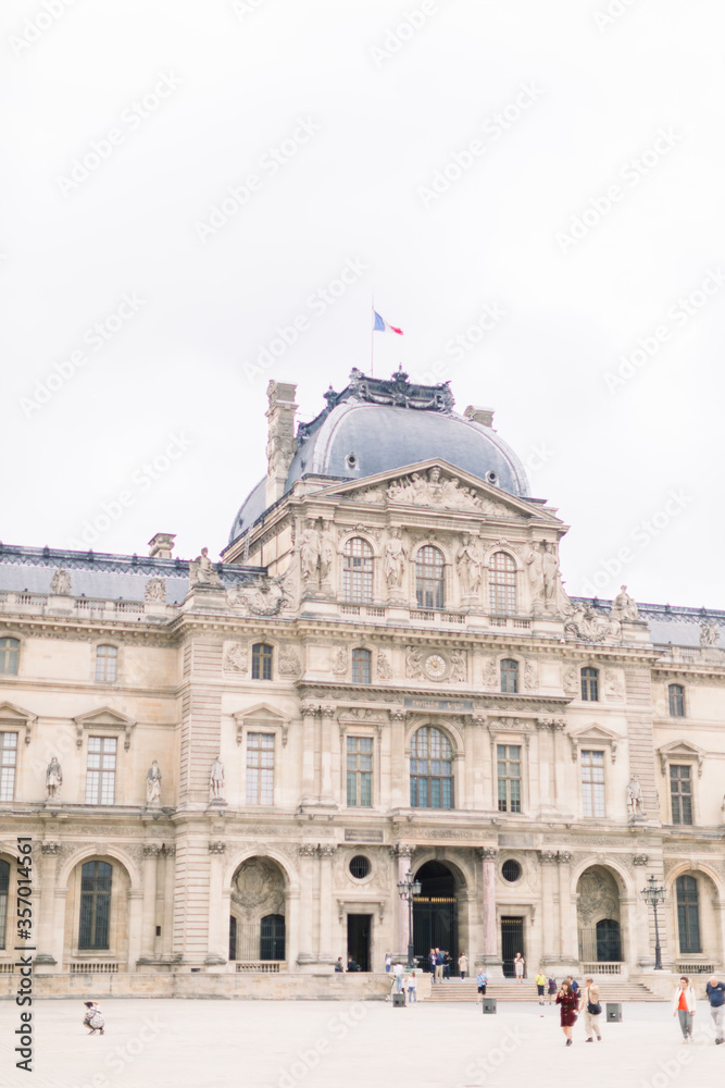 PARIS, FRANCE - September 17, 2019: Wonderful view of Louvre palace and unrecognizable people tourists visiting Louvre Museum. The main entrance to the Louvre Museum.