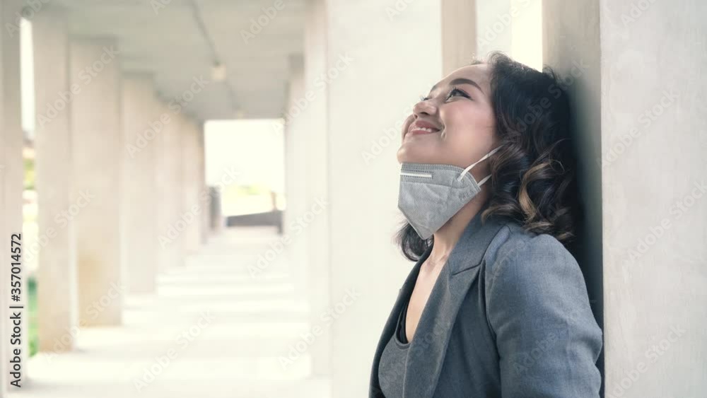 Woman takes off a medical mask, breathes deeply and smiles Woman takes off a medical mask, breathes deeply and smiles