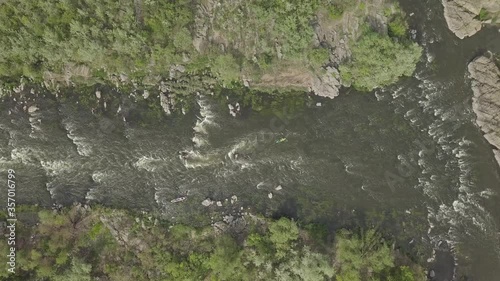 Aerial view to granite mountains and rapids on Southern Bug river, surrounded by trees and grasses, Mihiia village. Ukraine. Famous place for rafting and kayaking photo