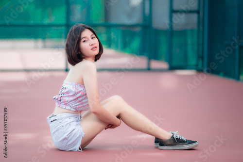 Portrait of hipsters girl pose for take a photo at tennis court,Thailand people,Lifestyle of modern thai woman