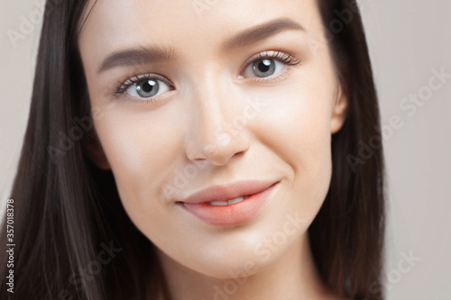 Young beautiful woman with clean perfect skin closeup