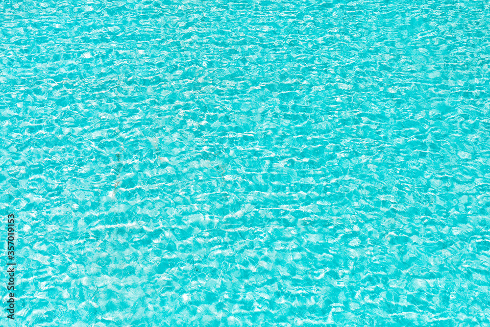 Textured background of turquoise water of tropical beach and refreshing swimming pool in summer for bathing Textured background of turquoise water of tropical beach and refreshing swimming pool in summer for bathing