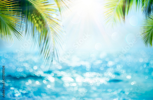 Blurred Blue Sky And Sea With Bokeh Light And Leaves Palm Tree - Summer Vacation Concept 