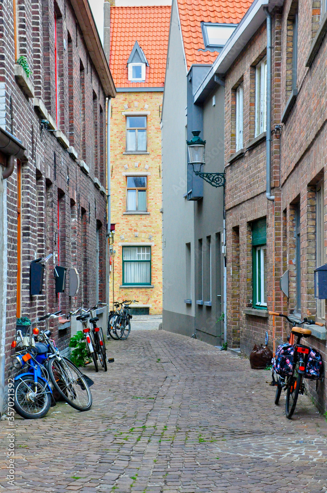 Colorful bicycle and stone buildings in Bruges , Belgium .