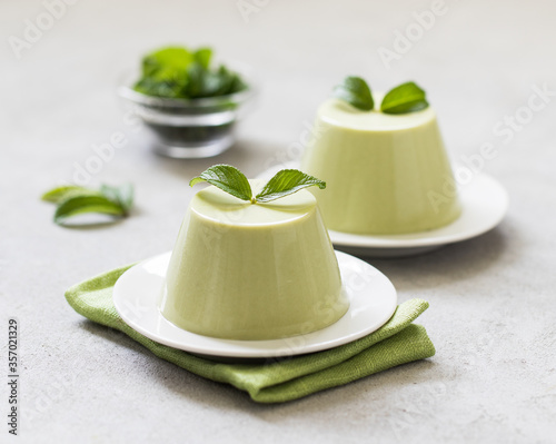 Italian Panna cotta with green matcha tea on a light background
