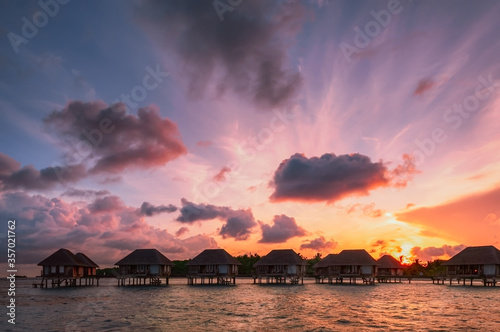 Maldivian water bungalows at sunrise