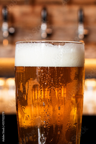 Wallpaper Mural A cold glass of craft beer over a pub table with bokeh background. Happy hour time. Torontodigital.ca