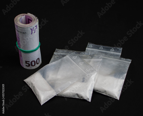 Isolated drugs in some plastic bags with a wad of five hundred euros notes