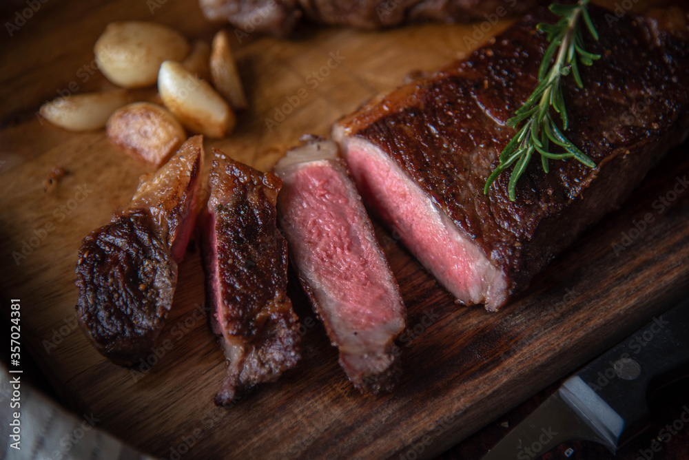 dark image of sirloin beef steak on wooden board