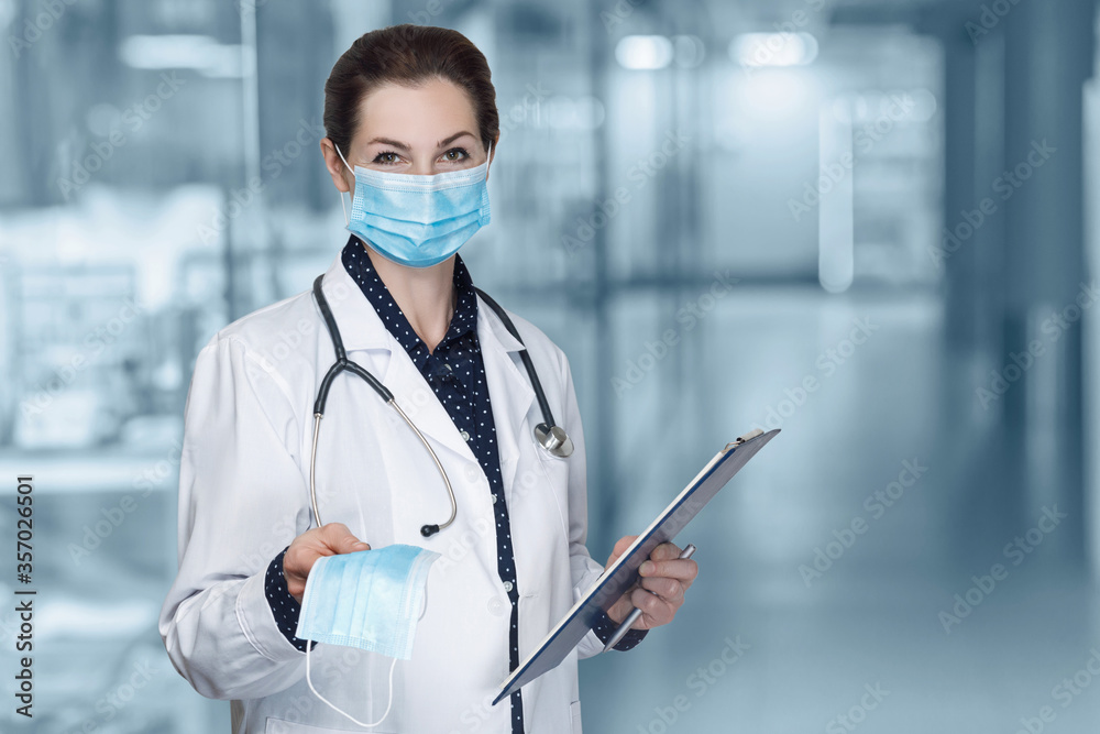 Doctor shows a mask as a means of protection against the spread of viruses . Doctor shows a mask as a means of protection against the spread of viruses .