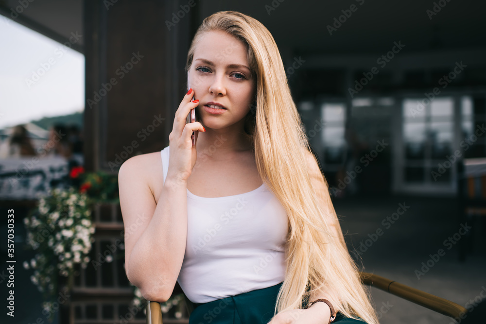 Young woman talking on smartphone in city Young woman talking on smartphone in city
