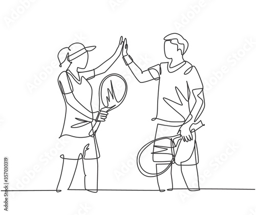 One line drawing of young fun couple male and female playing tennis at grass court together and giving high five gesture. Relationship concept continuous line draw graphic design vector illustration