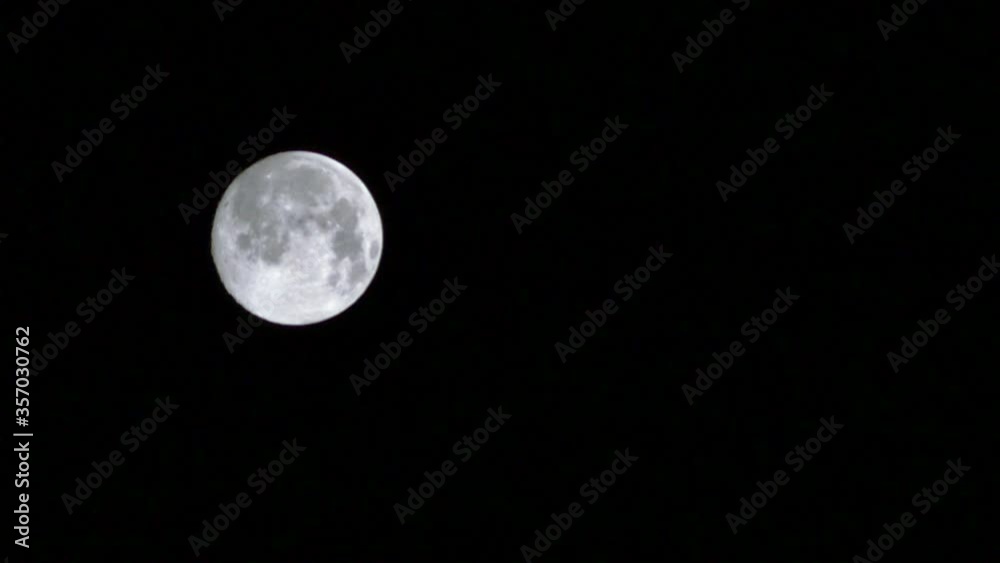 Full Moon Down Slowly. Time lapse of moon falling on dark night sky. Timelapse, 30 second, 30fps HD video. Moon appears high in the east at night. Black and White
Full Moon Down Slowly. Time lapse of moon falling on dark night sky. Timelapse, 30 second, 30fps HD video. Moon appears high in the east at night. Black and White