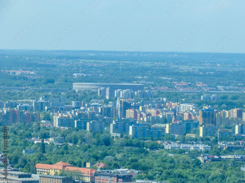 Fototapeta premium Wroclaw, Poland, May 28, 2017, aerial photo of Wroclaw's city staduim far away with some visible blocks of flats along the way.