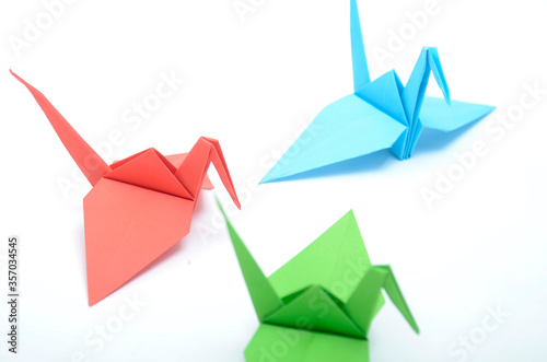 a colorfull origami paper bird, red, blue, green, yellow