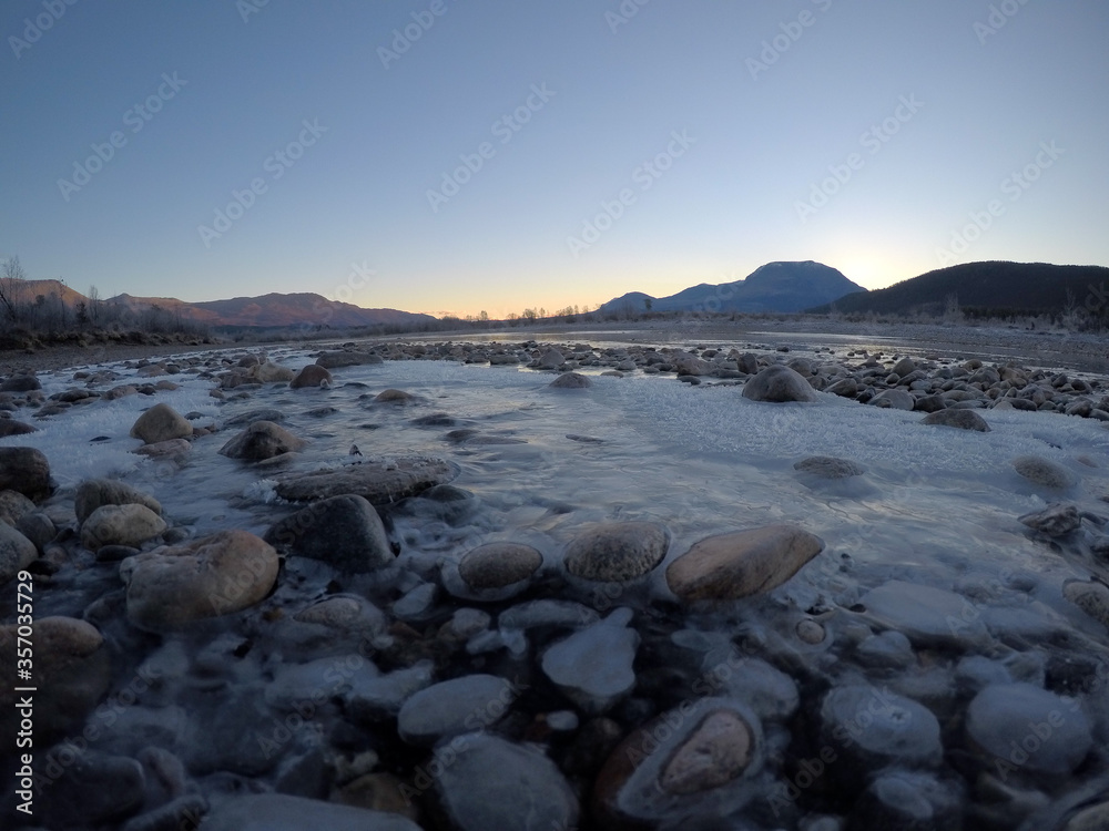 cold frozen river stream in late autumn