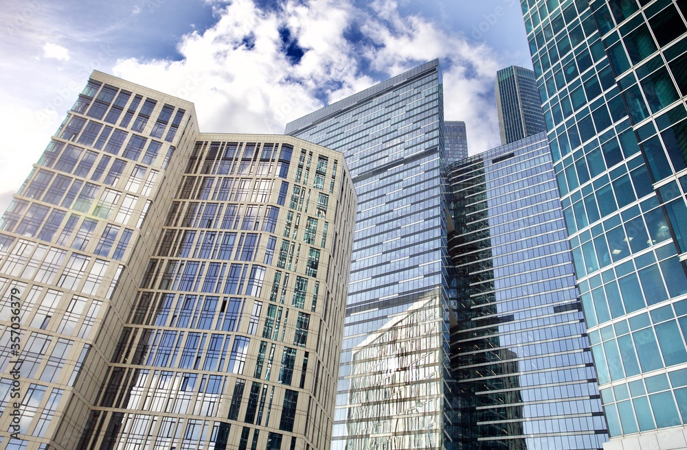 Office and residential skyscrapers on bright sun and clear blue sky background. Commercial real estate. Modern business city district. Office buildings exterior. Financial city district. City downtown