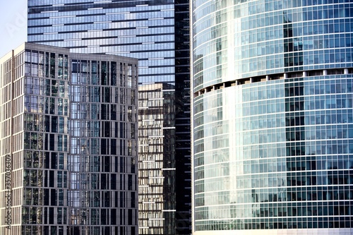 Office and residential skyscrapers in city downtown close up. Commercial real estate. Financial city district. Modern business city district. Office buildings exterior and facade design. In the city.