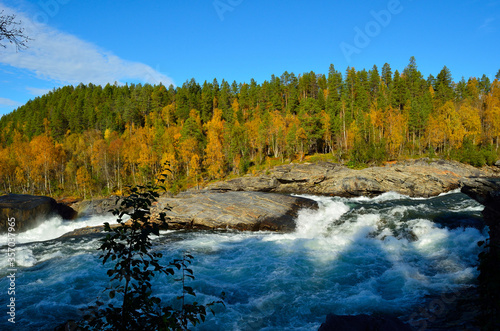 majestic colorful autumn landscape with mighty roaring waterfall