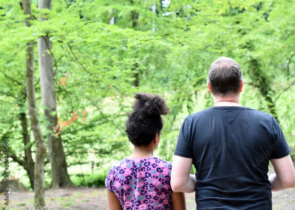 Grandfather and daughter walking in forest Grandfather and daughter walking in forest