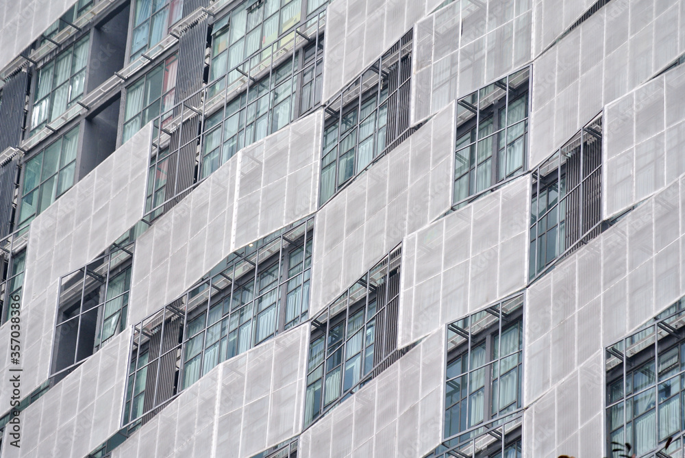 KUALA LUMPUR, MALAYSIA -JUNE 16, 2016: High rise building facade with sunshade devices to protect direct sun light entering the building. KUALA LUMPUR, MALAYSIA -JUNE 16, 2016: High rise building facade with sunshade devices to protect direct sun light entering the building.