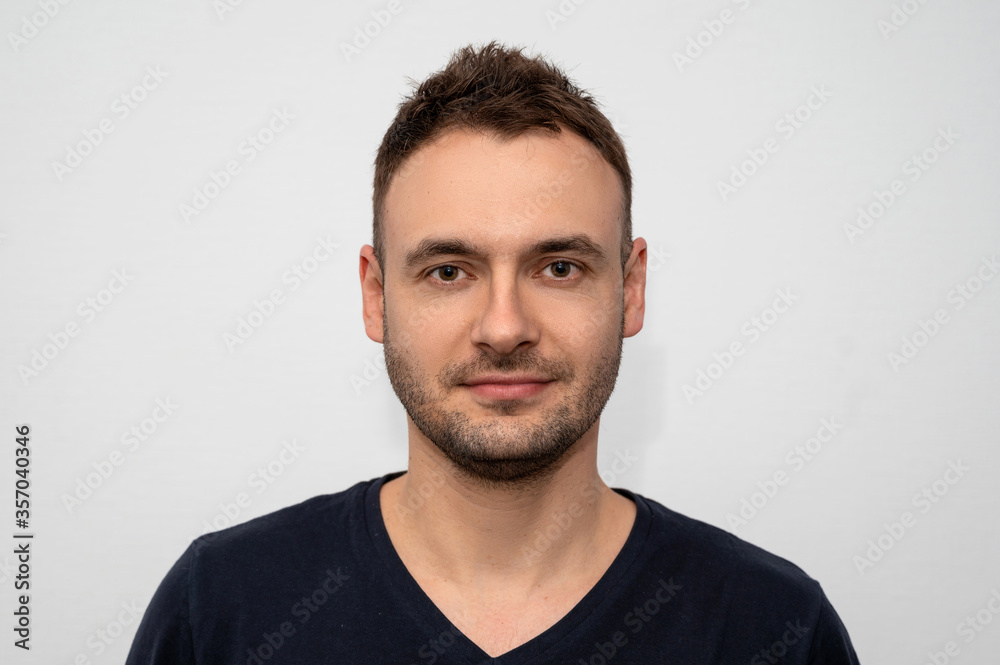Confident handsome guy with stubble and a new hairstyle in a barbershop. Photo For documents Confident handsome guy with stubble and a new hairstyle in a barbershop. Photo For documents