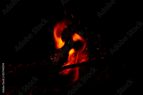 Bright orange fire with sparks. New year celebration. Concepts of cooking or fire event. Fire close up shot. Abstract background. 