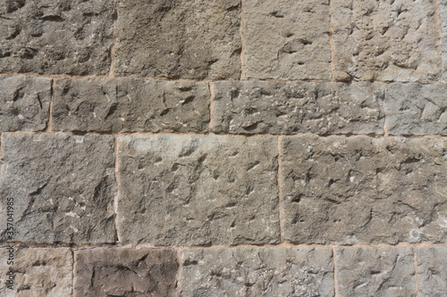 Ancient church wall texture. Rough stone wall pattern. Old rock wall.