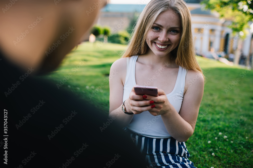 Joyful young female using cellphone in park Joyful young female using cellphone in park