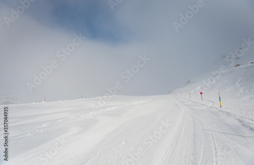 Spring alp scenery from Molltal glacier. Ski slope with skier in fogge april day. © Сергій Вовк