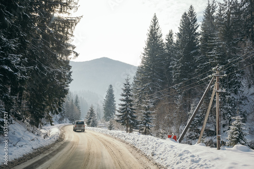 A path with trees on the side of a snow covered slope