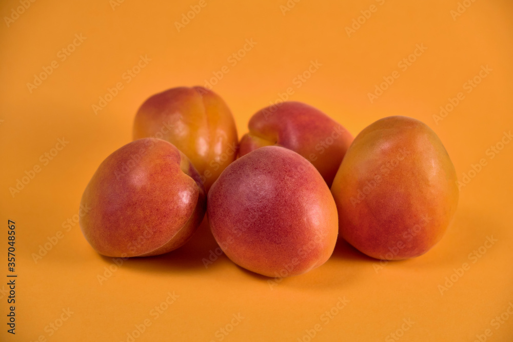 Fresh juicy apricots in a transparent glass plate. Macro. Fresh juicy apricots in a transparent glass plate. Macro.
