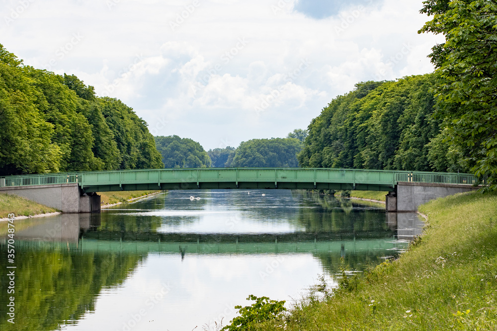 green metal bridge at a lake in Cologne, Decksteiner Weiher
