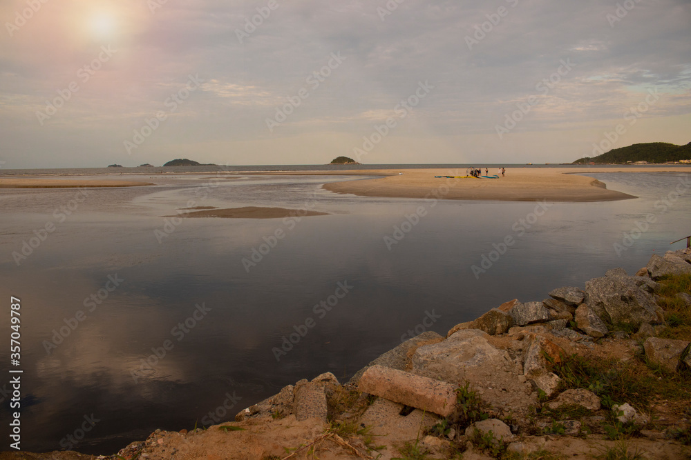 Landscape of a beach with golden sand and large stones, natural lake formed by the waters of the ocean. End of the day, sunset
Brazilian beach
