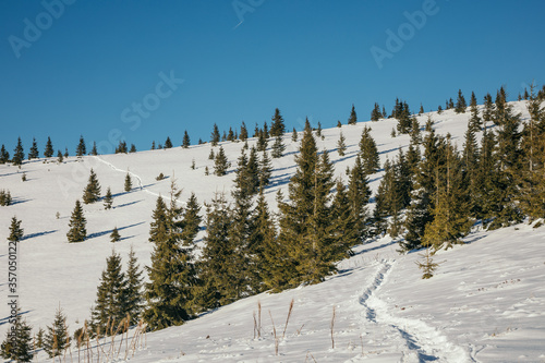 A man flying through the air on a snow covered slope
