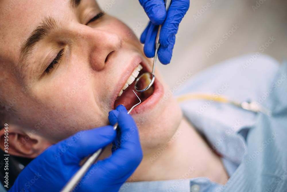 Fototapeta premium Boy at the dentist consultation. Checking and dental treatment in a clinic.