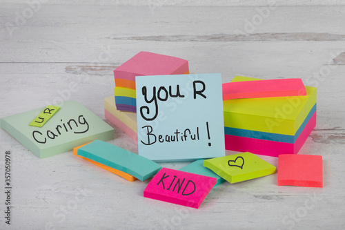 You are beautiful words of inspiring affirmation caring kind stack of piled posted notes   photo
