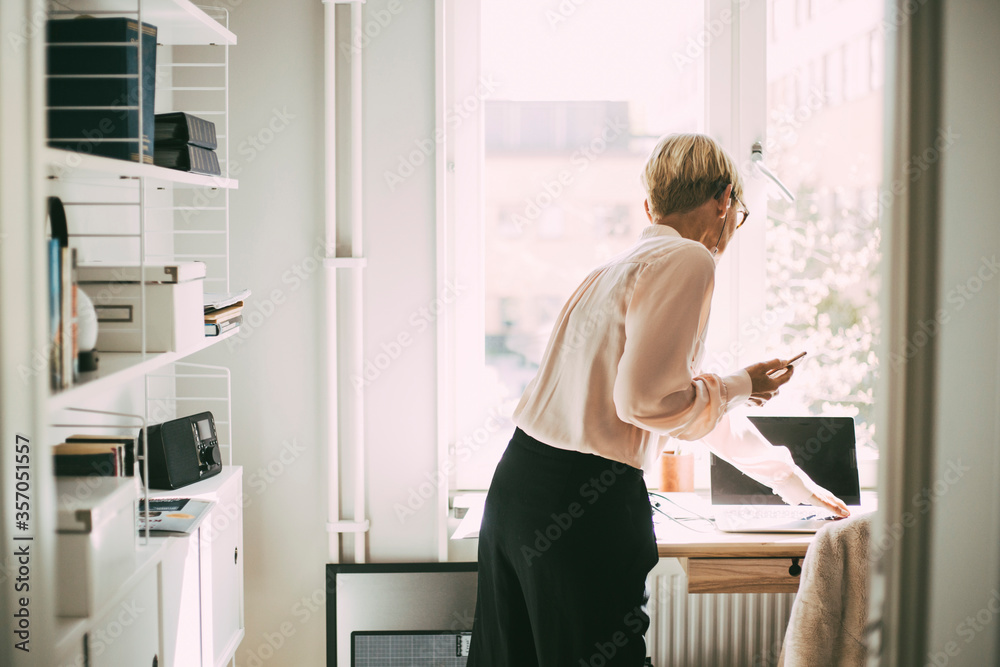 Woman in office at home on the phone Woman in office at home on the phone