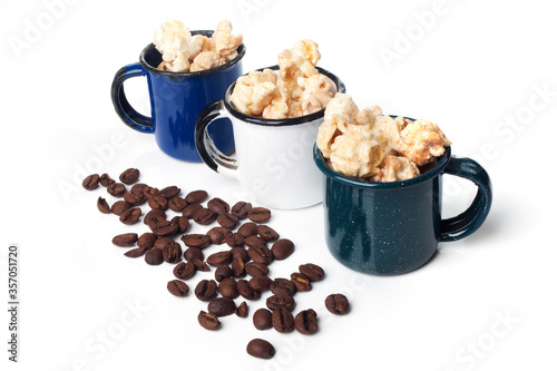 Amazing view of gourmet cinnamon and coffee popcorn with rustic utensils over a white background.