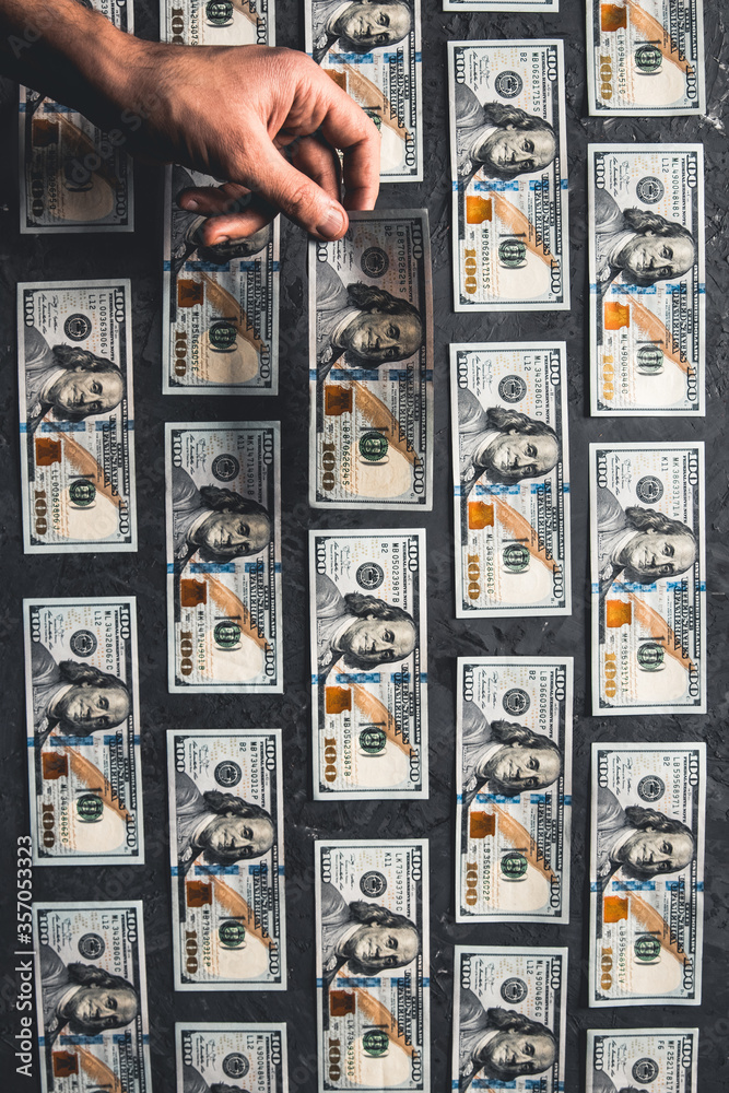 One hundred dollar bills are creatively laid out. Business concept, development perspective. One hundred dollar bills are creatively laid out. Business concept, development perspective.