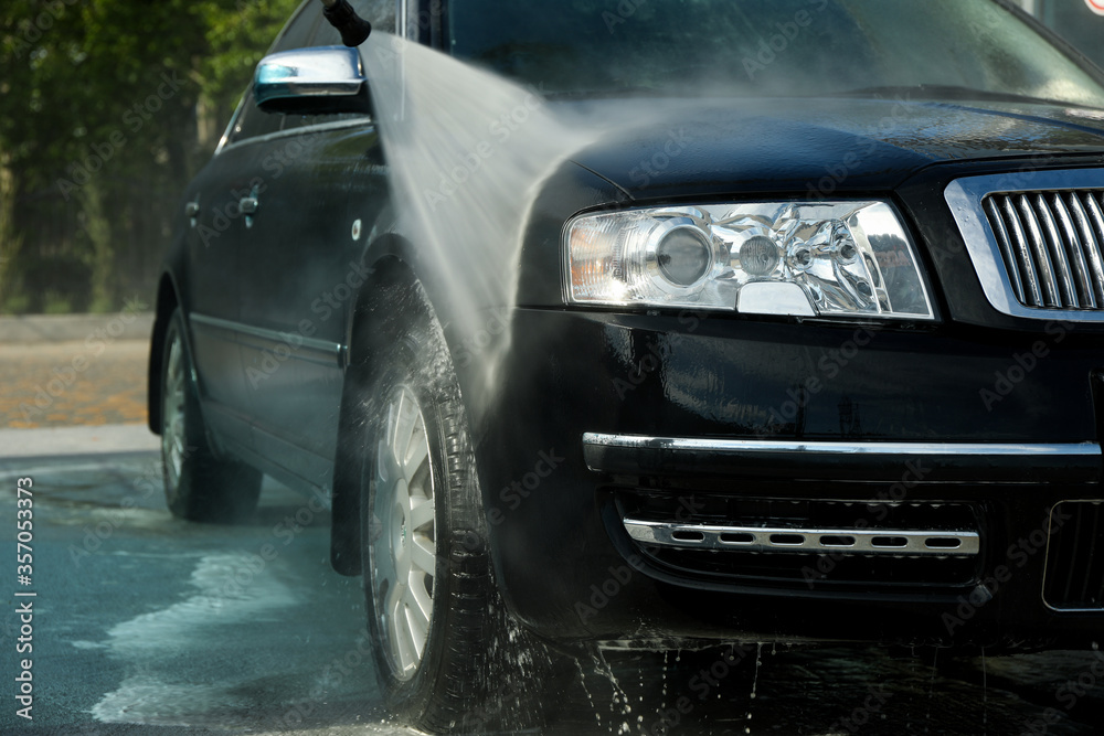 Car wash. Clear car concept. Wash black sedan