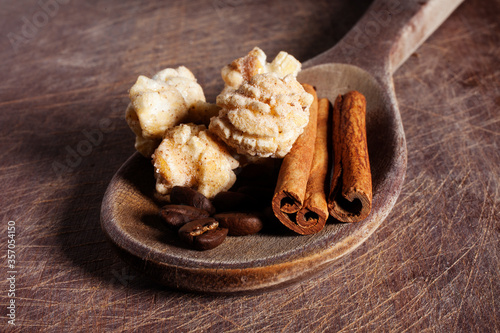 Gourmet cinnamon and coffee popcorn on wooden spoon over a wood cutting board background.