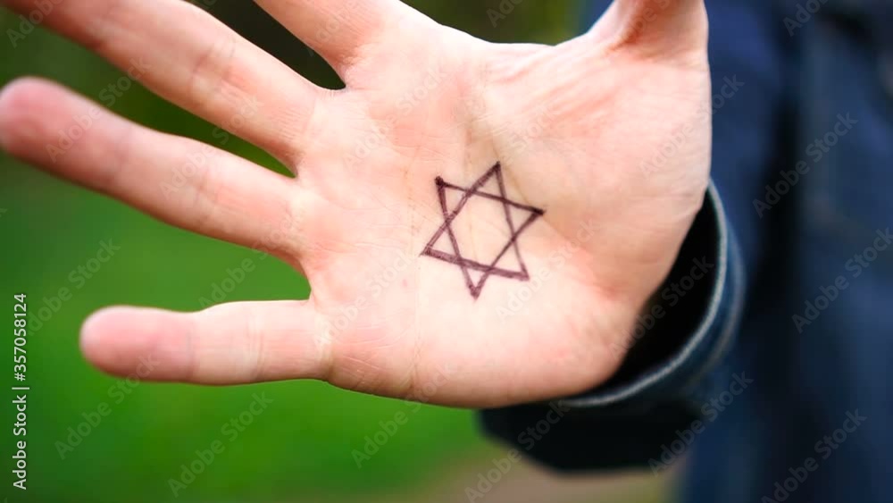 Hand with the symbol of modern Jewish identity on the palm: Star of David